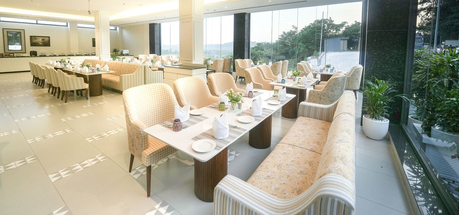 An image of a restaurant with tiled flooring, cosy furniture, and dining tables near a floor-to-ceiling window - NAMAMI BY ZENQ BANKHANDI