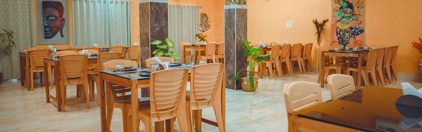 image of a well lit dining area with proper seating arrangements for the guests - Dip Holidays, Birbhum