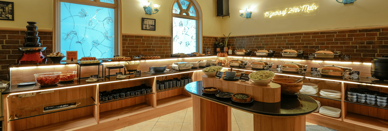 A buffet area with a variety of vegetarian dishes and a well-organised layout - Cross Roads Inn, Bengaluru