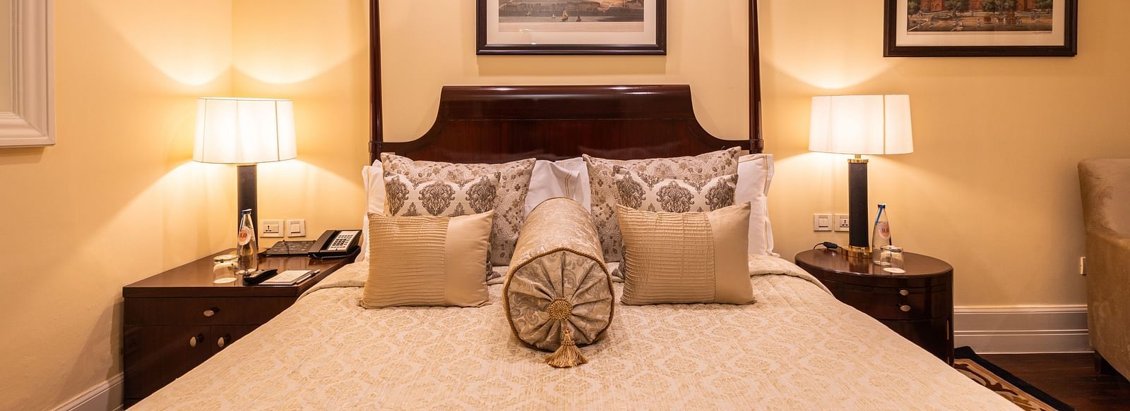image of a king size bed with table lamps at both sides of the bed at heritage parlour rooms - The Claridges New Delhi