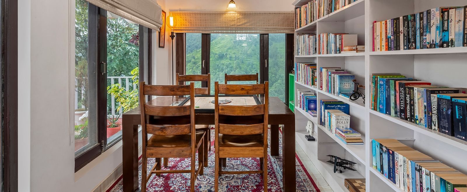 Cosy reading corner with bookshelves and window-side seating, at BluSalzz Collection - Suvaasa Resort, Ramgarh.