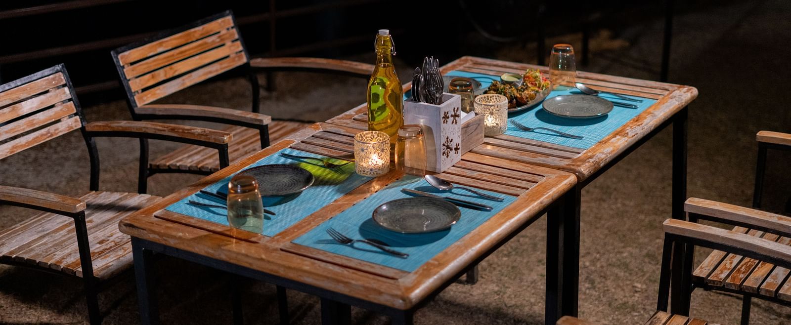 Outdoor dining space in the evening featuring chairs and a table at BluSalzz Escapade Resort, Lansdowne.