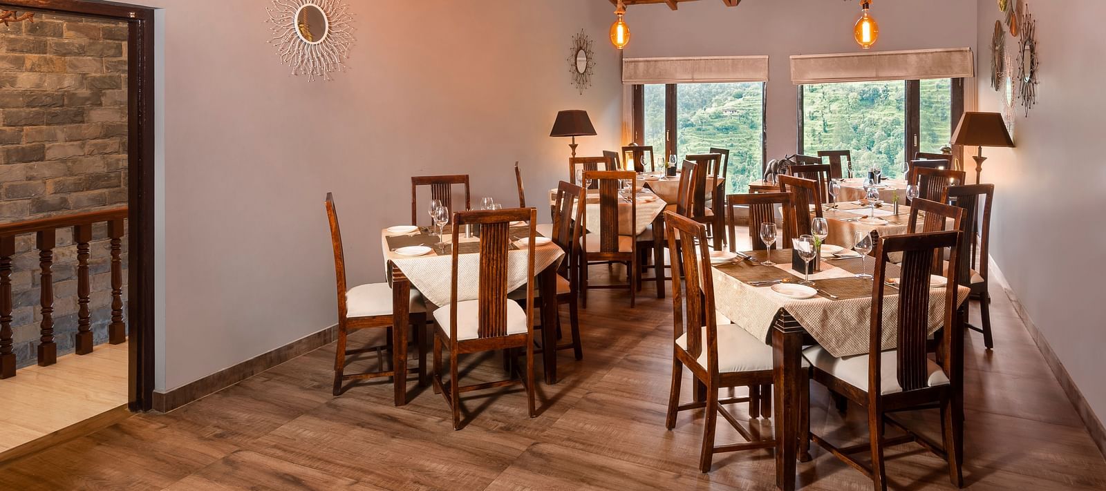 Rustic indoor dining area with wooden furniture and sloped ceiling, at BluSalzz Collection - Suvaasa Resort, Ramgarh.