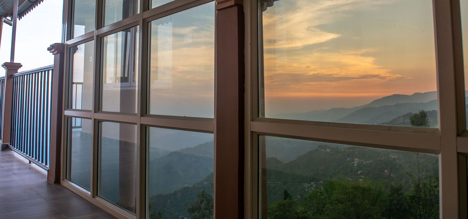 A facade image showing a window with reflection of the Himalayan mountains - Avianna Windy House Wellness Retreat & Spa