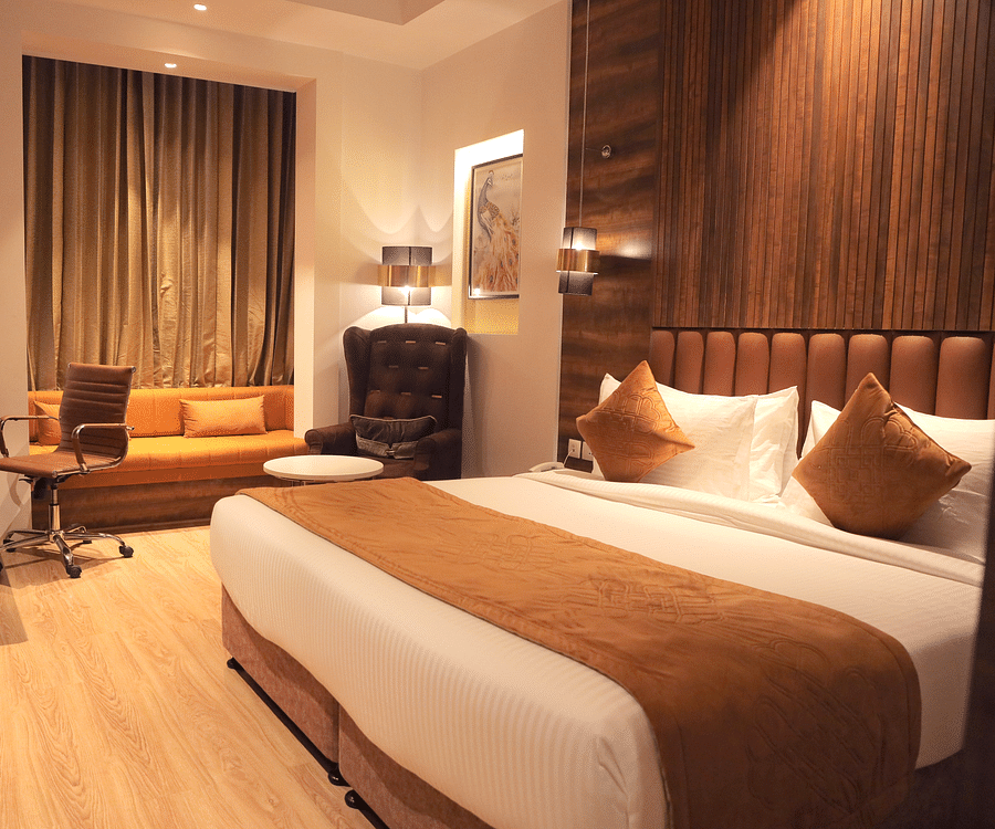 alt-text room with a king size bed and wooden flooring at best western vrindavan