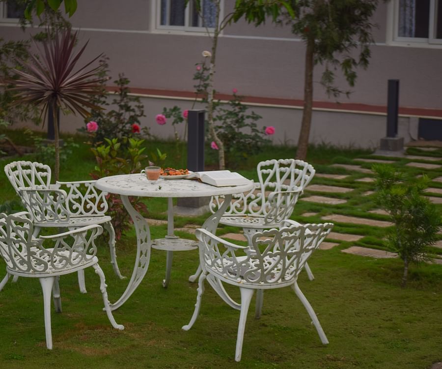 steel table and chairs on the garden at Ibex Stays & Trails, Kotagiri