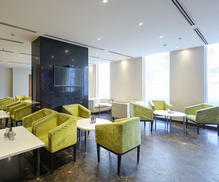 Side view of black velvet bar area with seating at Icon Premier Hotel by Bhagini, Devarabisanahalli