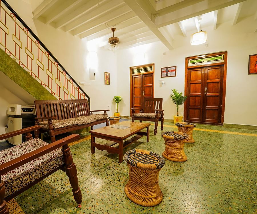 alt-text The living area with sofas and a coffee table and steps leading to the 1st floor inside superior villa - La Villa Heritage, Pondicherry