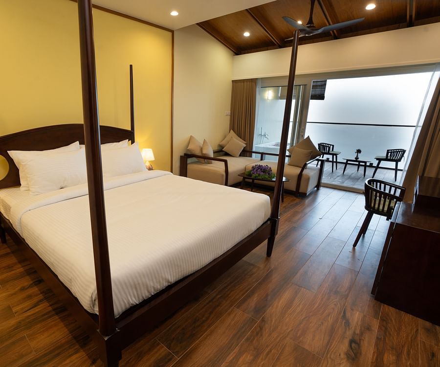 A bed in a room with a mountain view | Misty Queen by Dimora, Kakkadampoyil