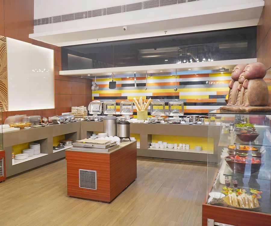 A side angle view of buffet counter at Nemesia restaurant featuring a variety of desserts.