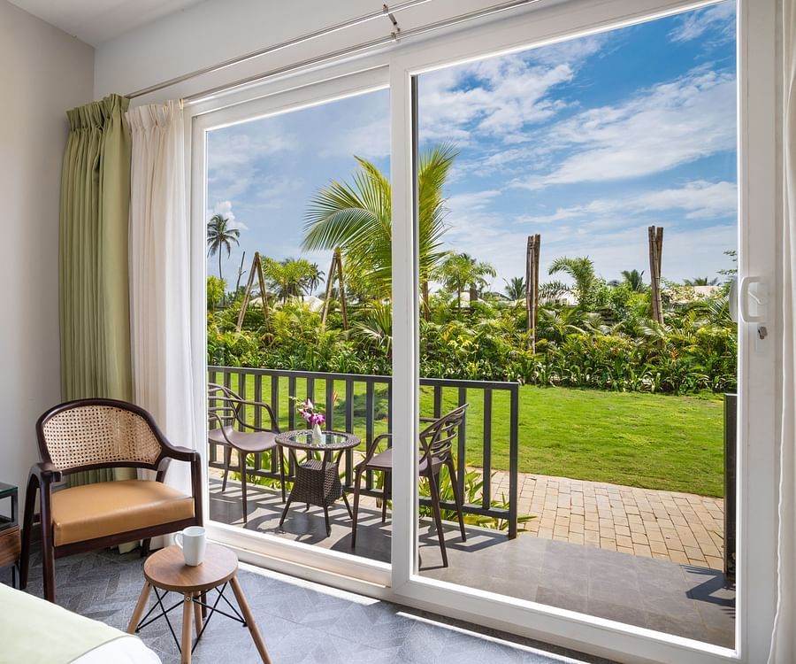 image of the beautiful scenic view from the huge french windows of the premium cottage at sibaya beach resort, morjim beach