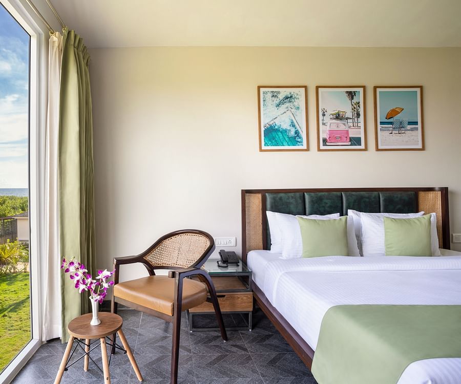 Premium Suite that features a queen size bed along with an arm chair with beautiful views from the window besides it