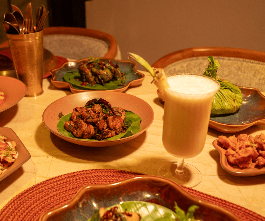 Assorted dishes and beverages served on a dining table at Jamun restaurant - Symphony Resorts