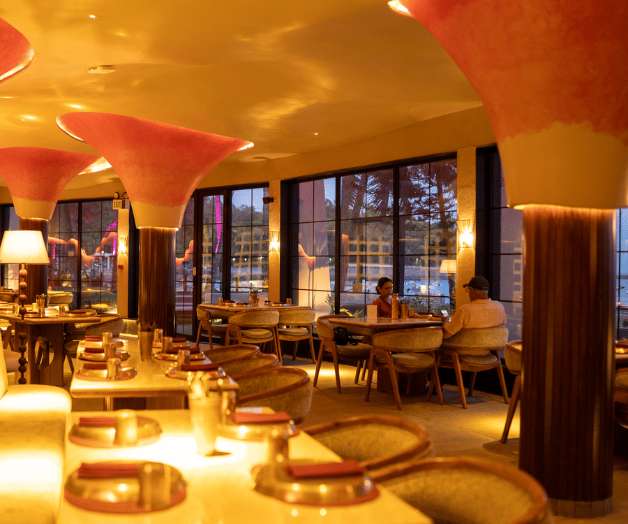 Spacious interiors of Jamun restaurant with seating and illuminated ceiling design-Symphony Resorts