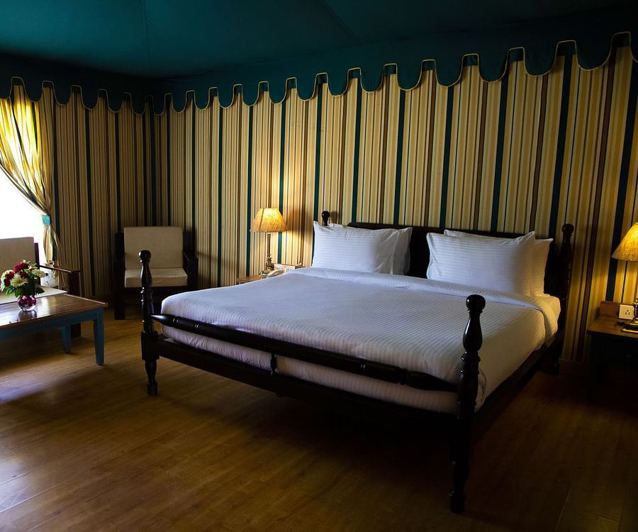 A spacious bedroom with a large bed and a sofa