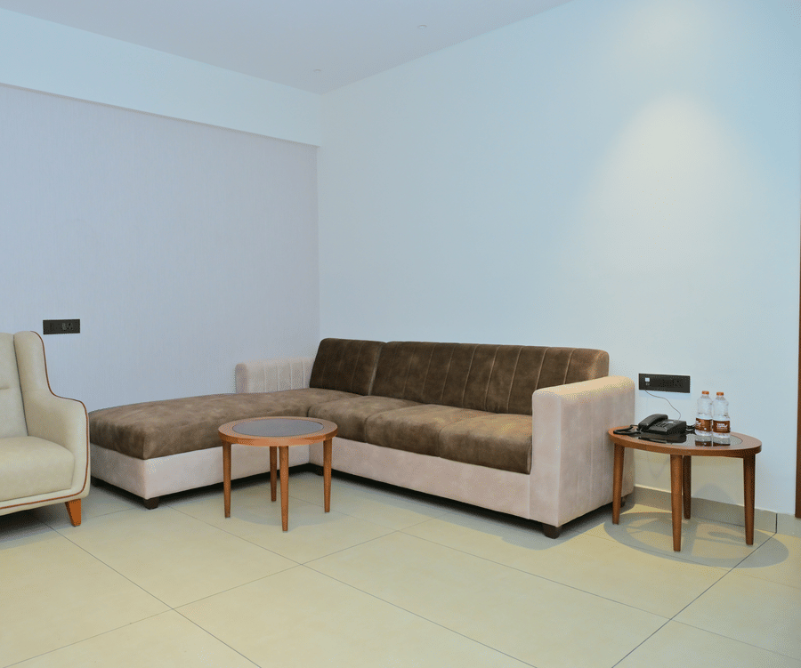 Lounge area of Bhavanis Vista By Icon featuring a sofa, an armchair, and a coffee table.