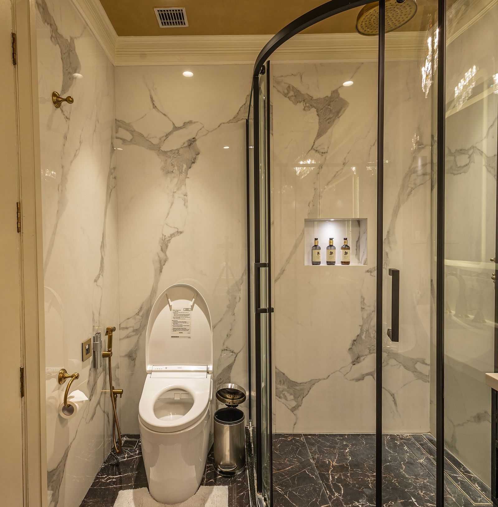 Washroom of the Executive Suite at The Claridges New Delhi, featuring a glass-enclosed bath area situated in the corner