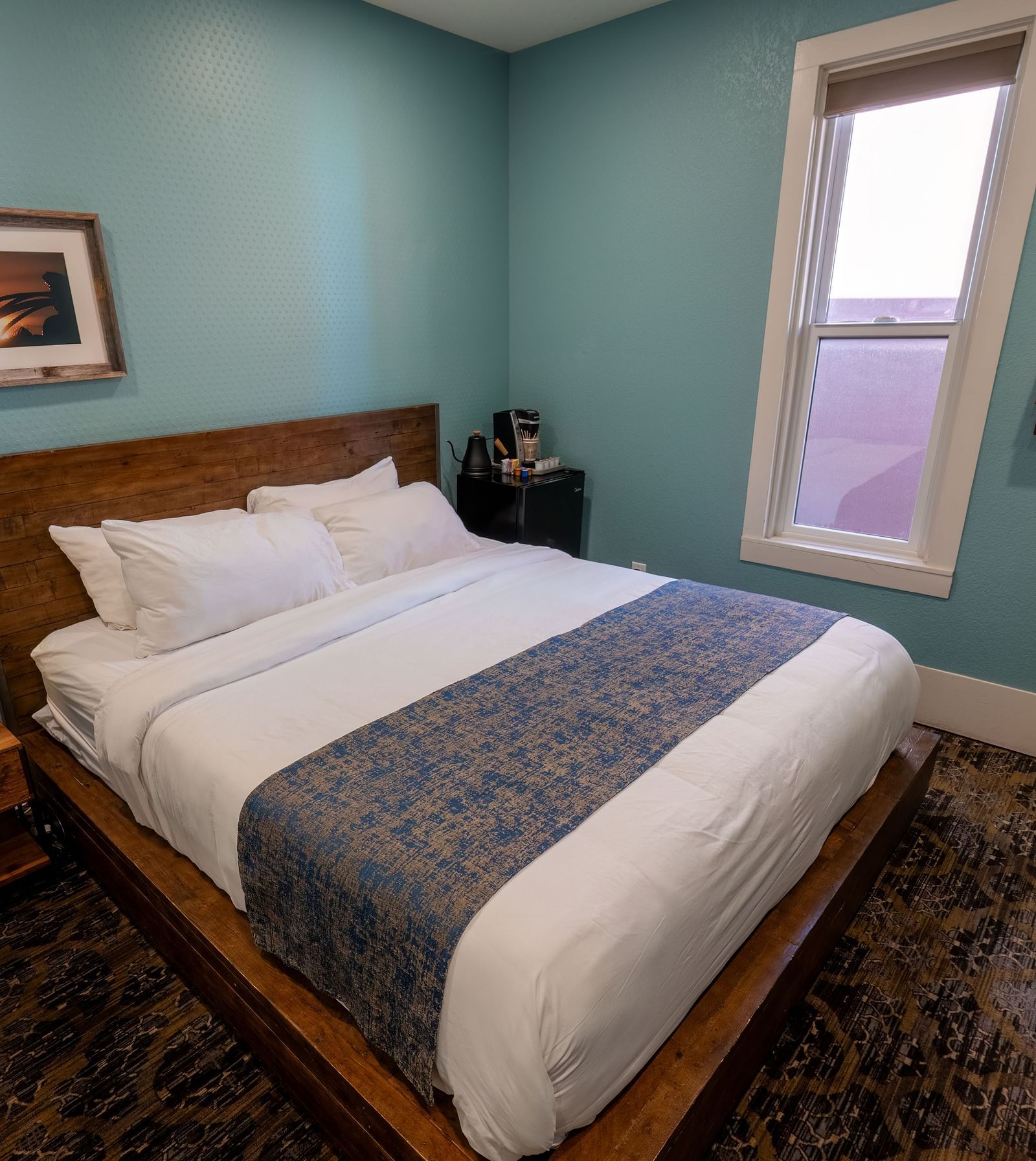 Elegant guest room with a plush bed and soft lighting for a restful stay at The Groveland Hotel.