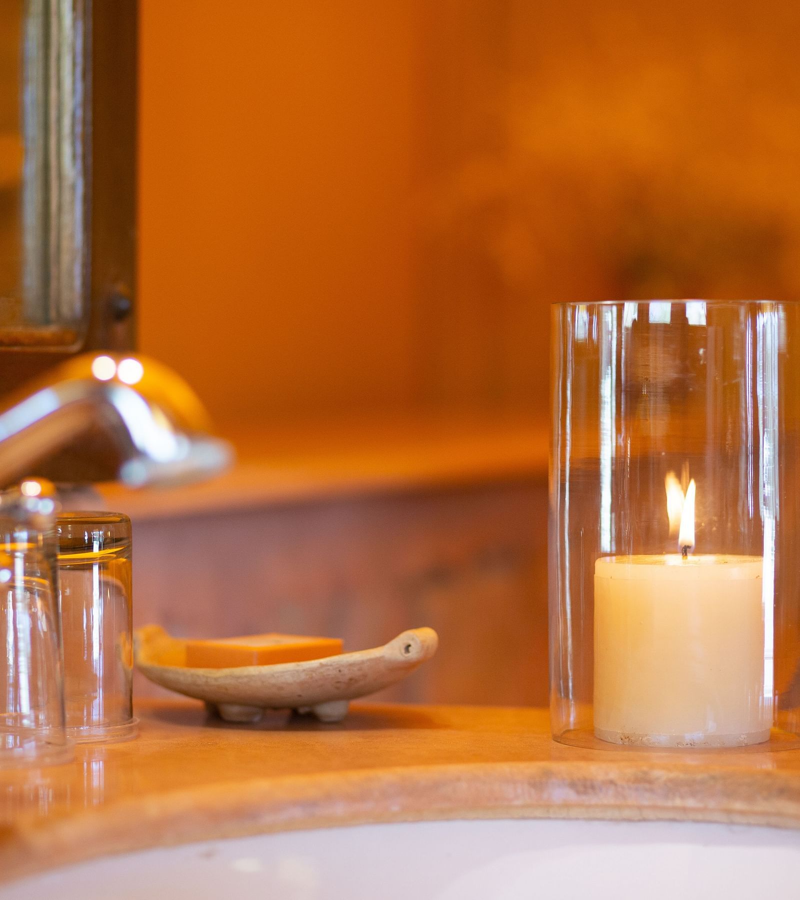 A candle lit inside the washroom