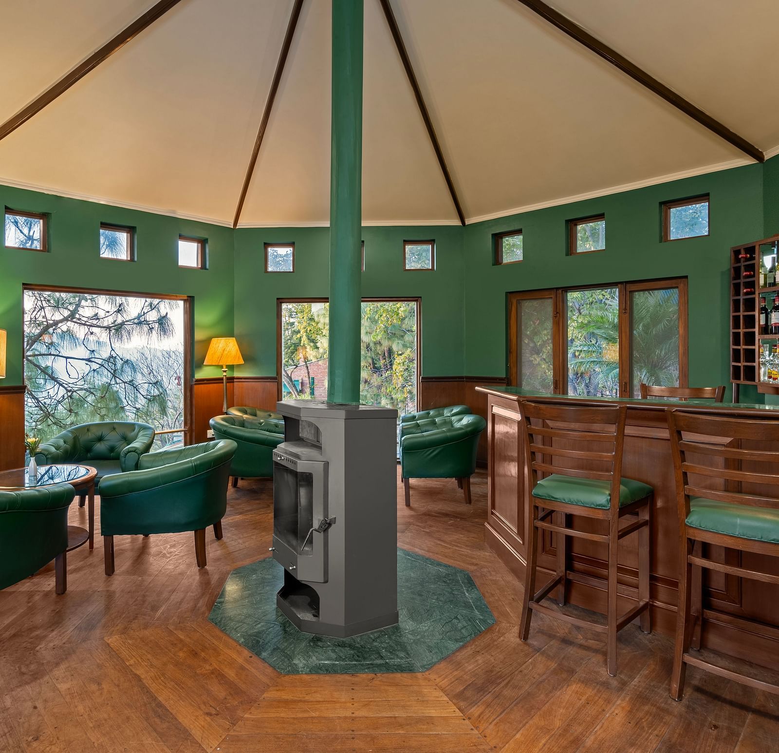 Beautiful and wooden interior of bar with chairs and sofas at Baikunth resort, kasauli.