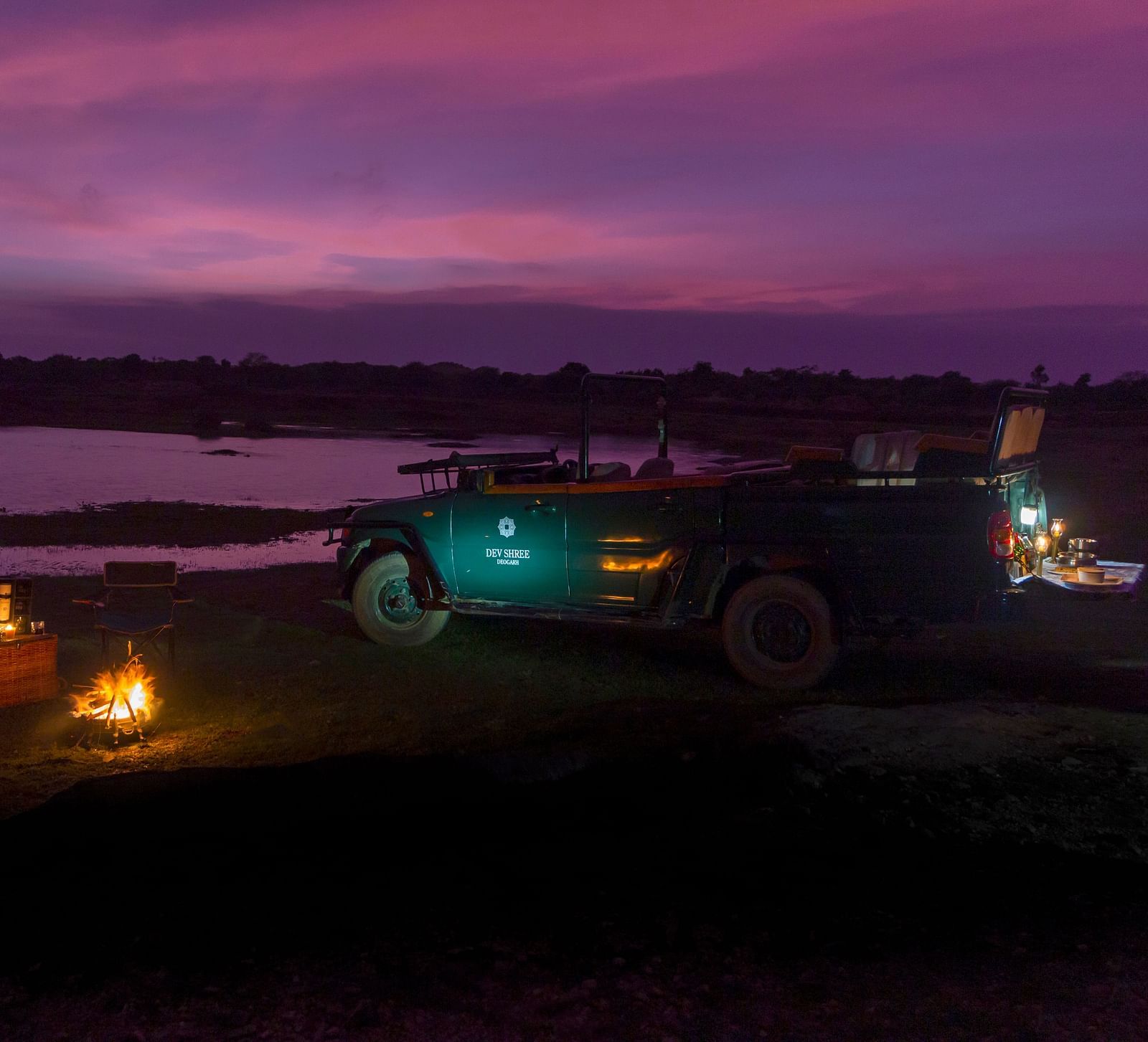 image showing the camping experience near a lake at Sunset at dev shree, deogarh