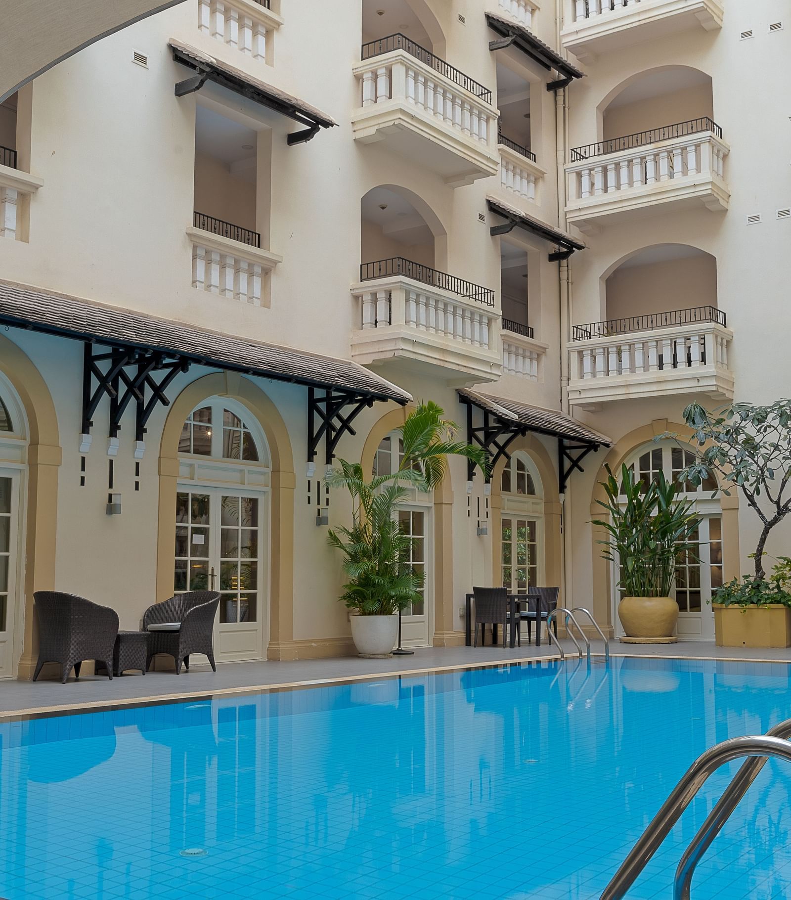 An exterior view of a building with a swimming pool | Central Mansions, Phnom Penh