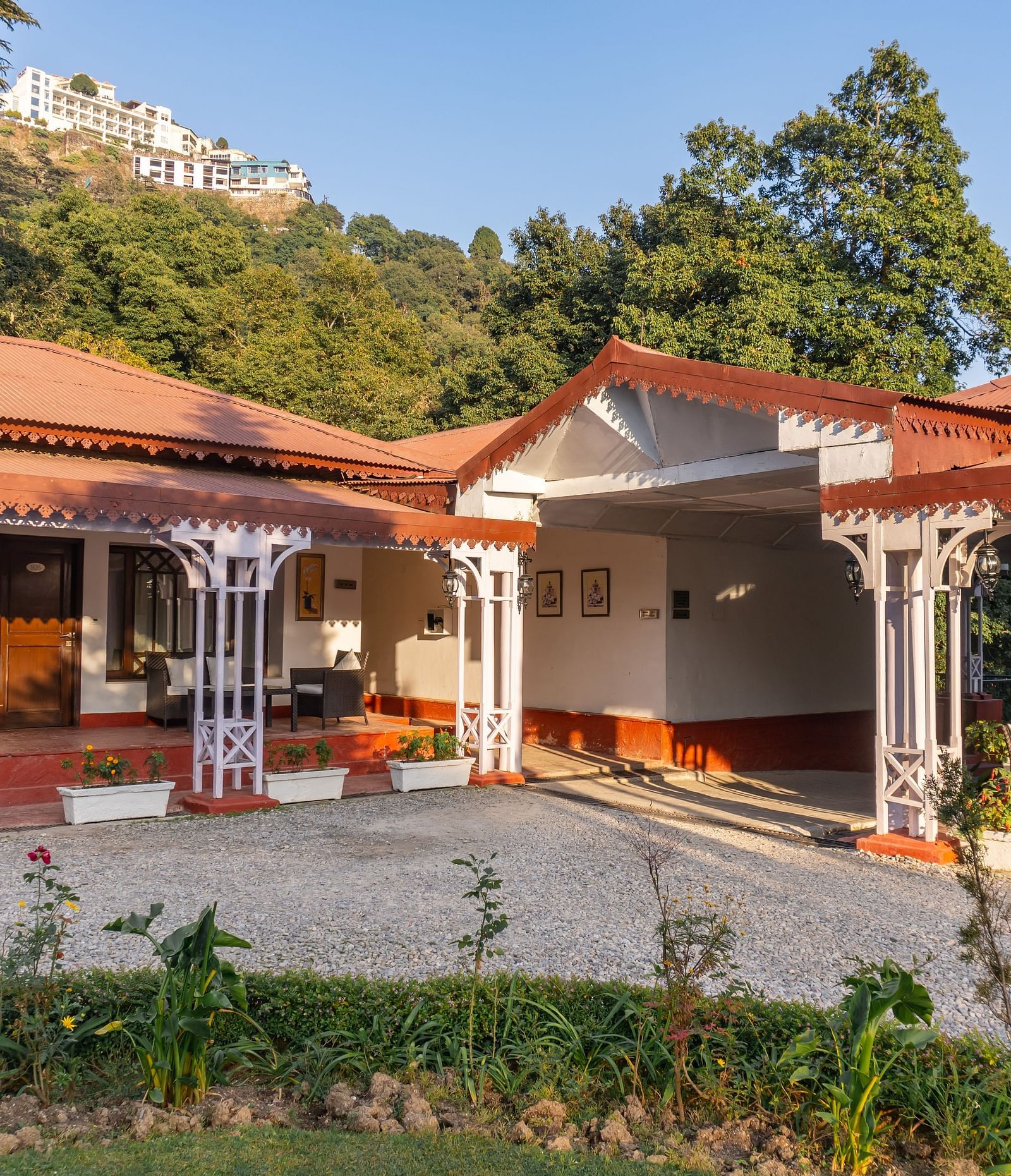 a facade image of our hotel in Mussoorie during a sunrise - The Claridges Nabha Residence