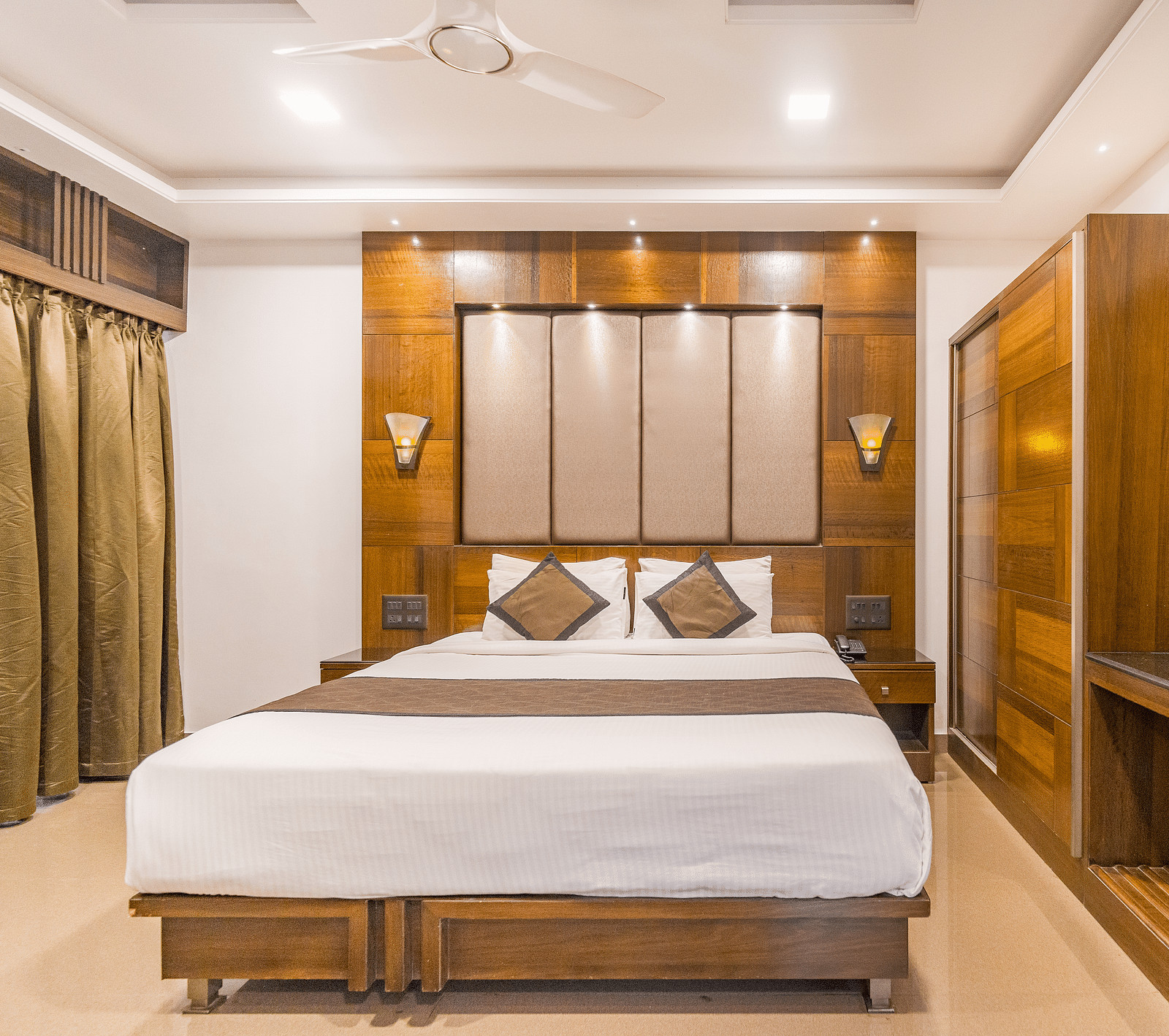 A room with a bed and a window on the side at Hotel Altitude, Madikeri.