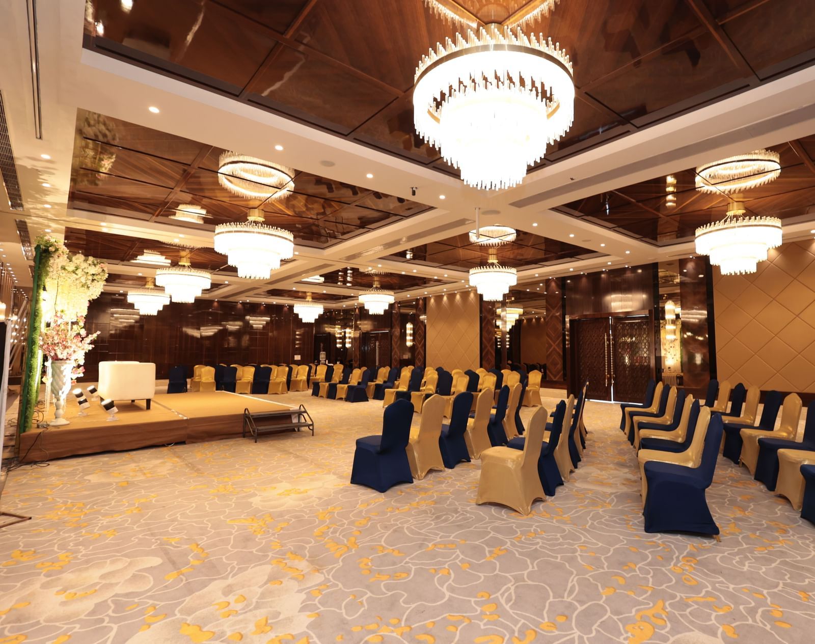 A side view of a banquet hall with chairs arranged around the stage area | Cenneys Gateway