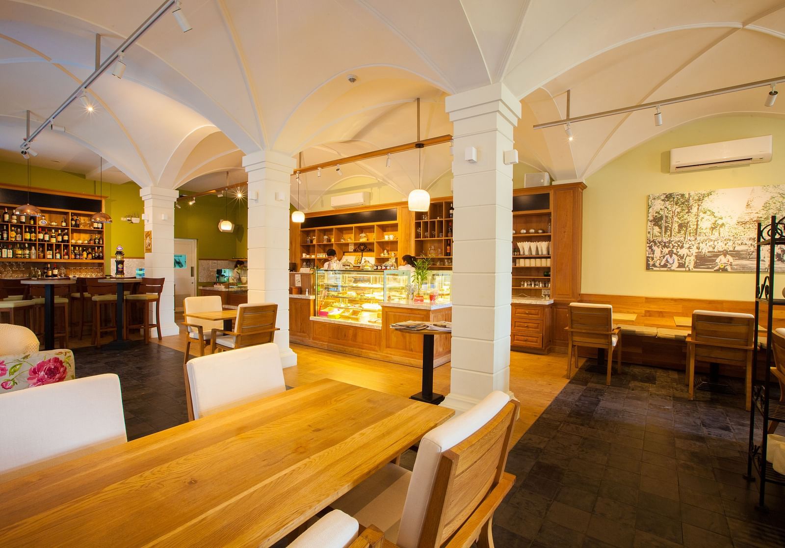 A view of an interior of a restaurant with tables and chairs | The Shop | Central Mansions, Phnom Penh