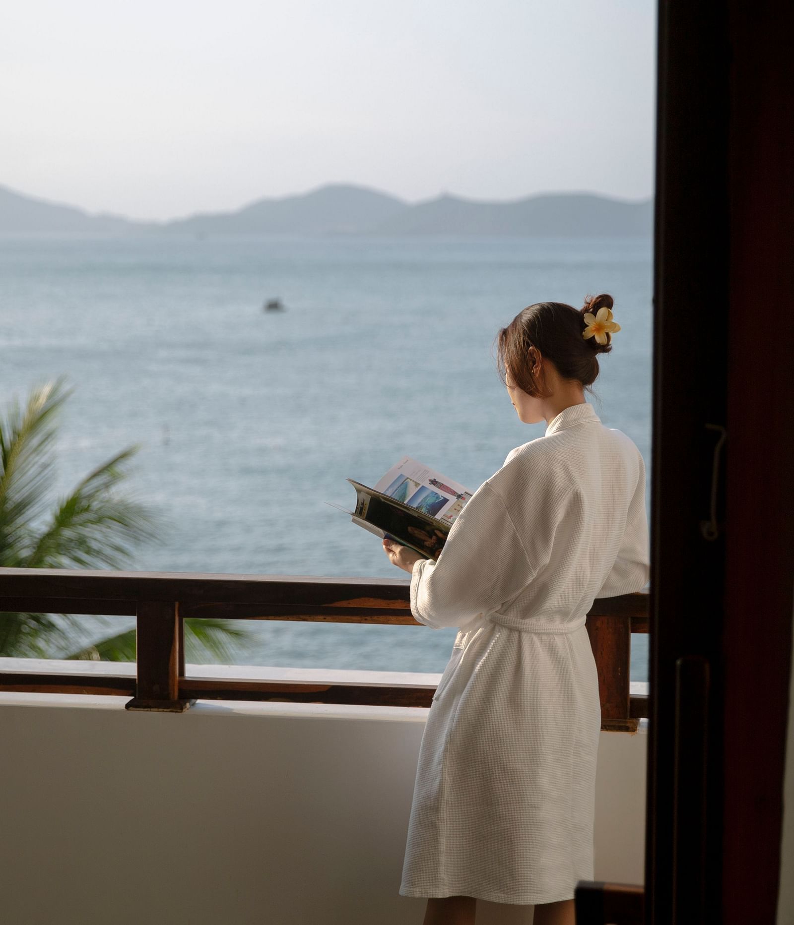 A person standing in the balcony - Alibu Resort Nha Thrang