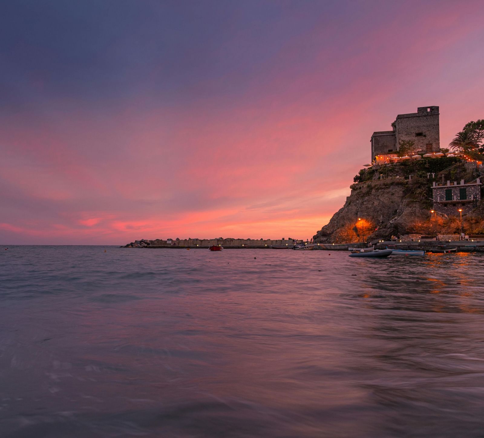 A view of the fort from the opposite shore, with the sunset in the background