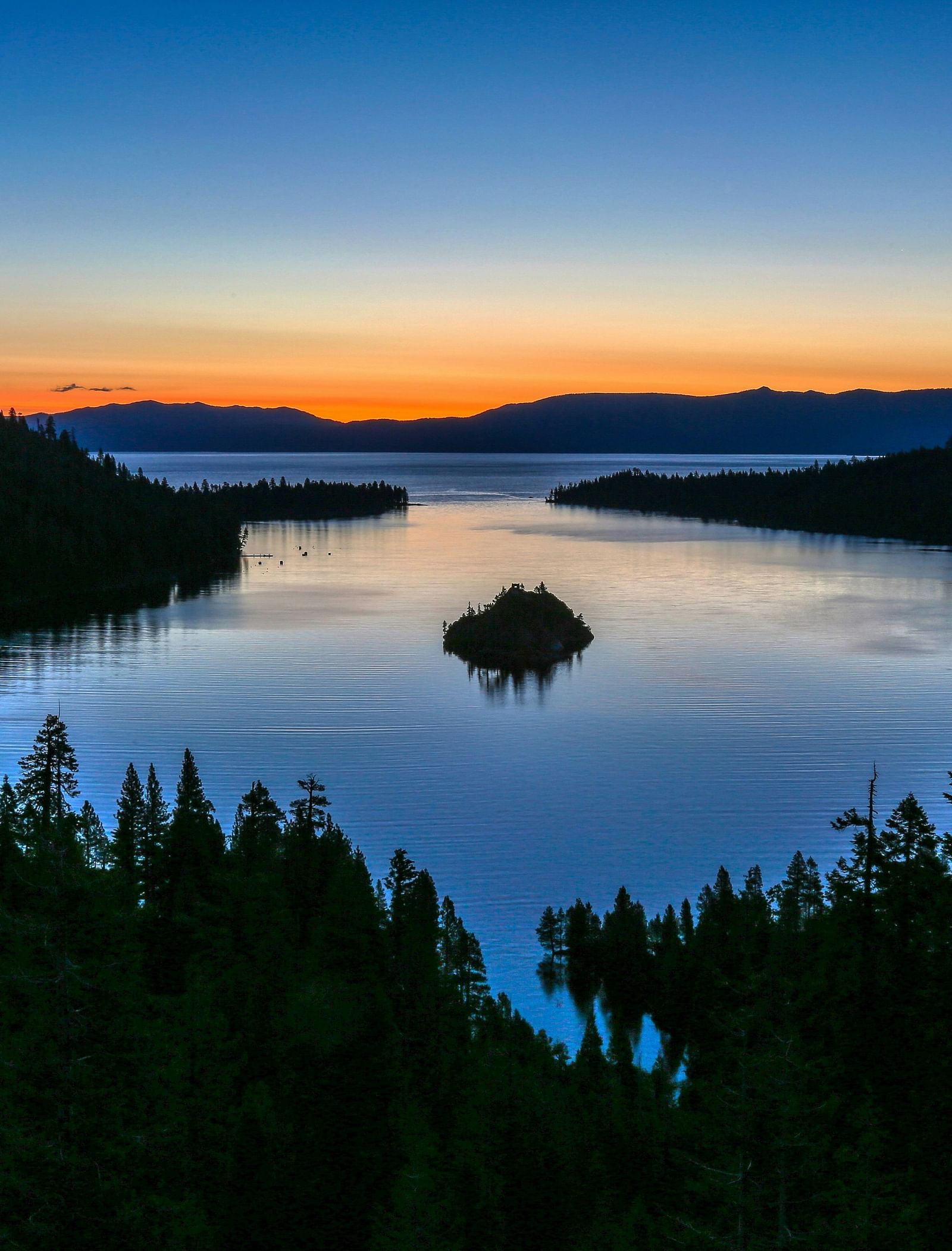 Emerald Bay at sunset, with the golden light reflecting on the water surrounded by trees