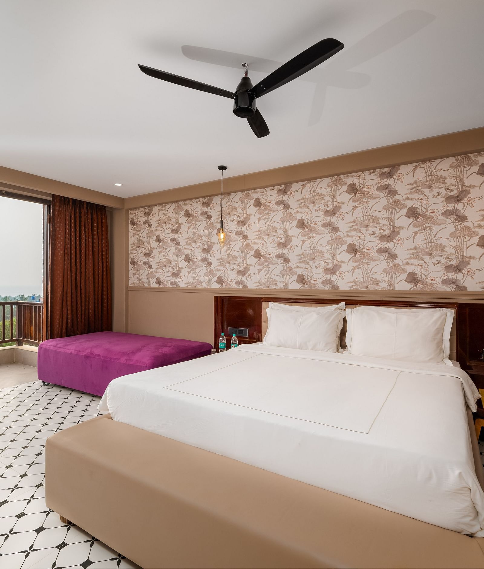An image showcasing a spacious bedroom with elegant interiors and modern amenities at Crescent Resort, Goa