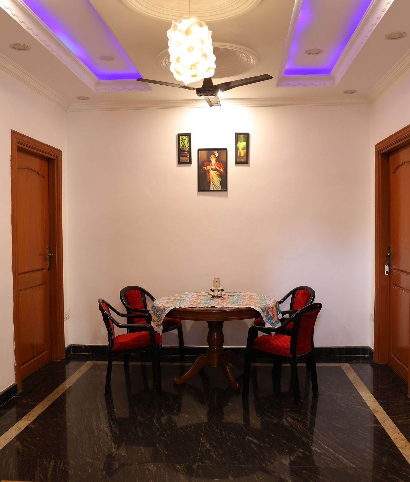 Image of a living room with a table and chairs around it at Villa Serenity Le Sejour, Pondicherry.