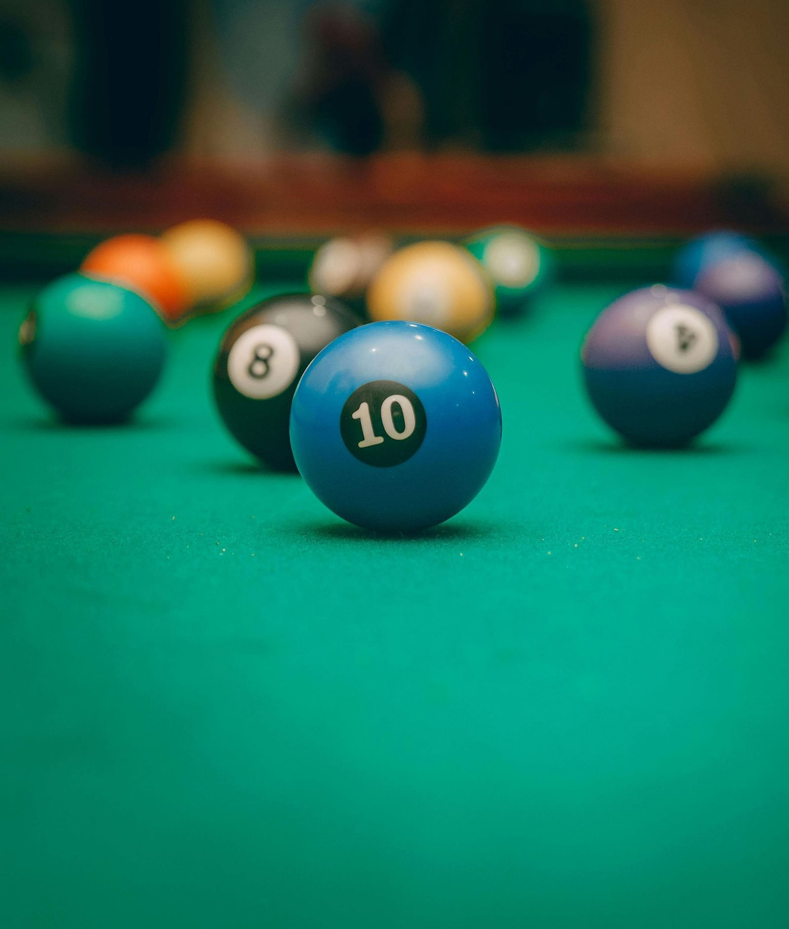 Pool table with balls spread across it