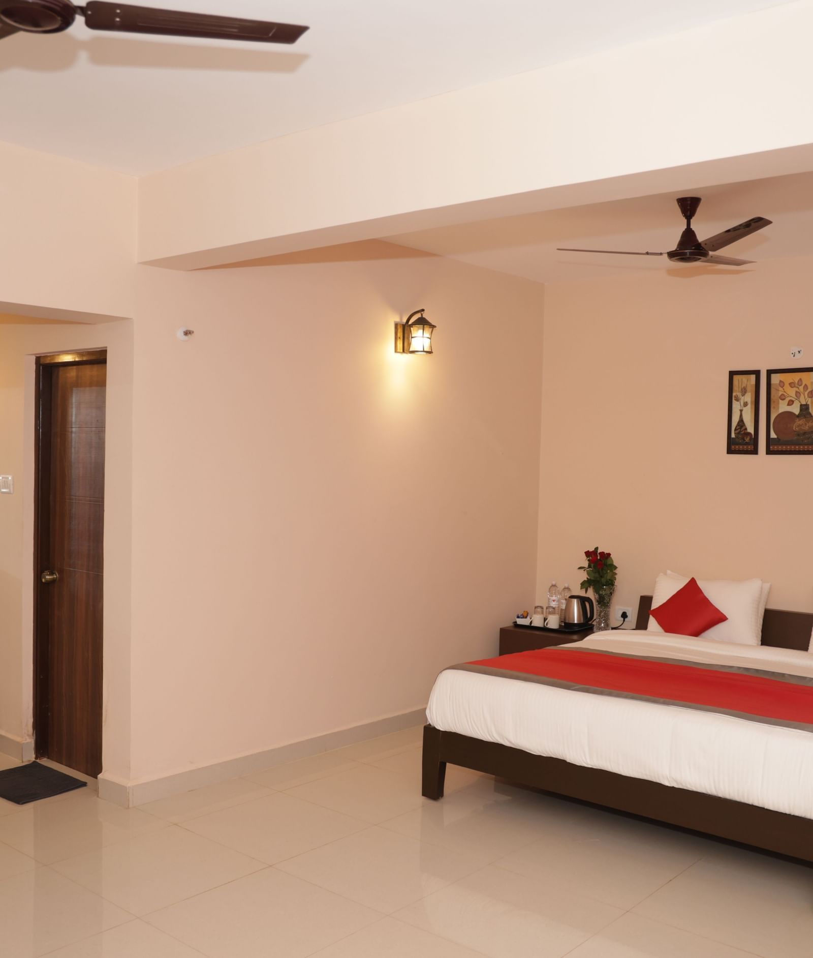 A wide-angle view of a bedroom at Nazri The Verda Hotel, Arambol, featuring a bed, ceiling fans, and open floor space.