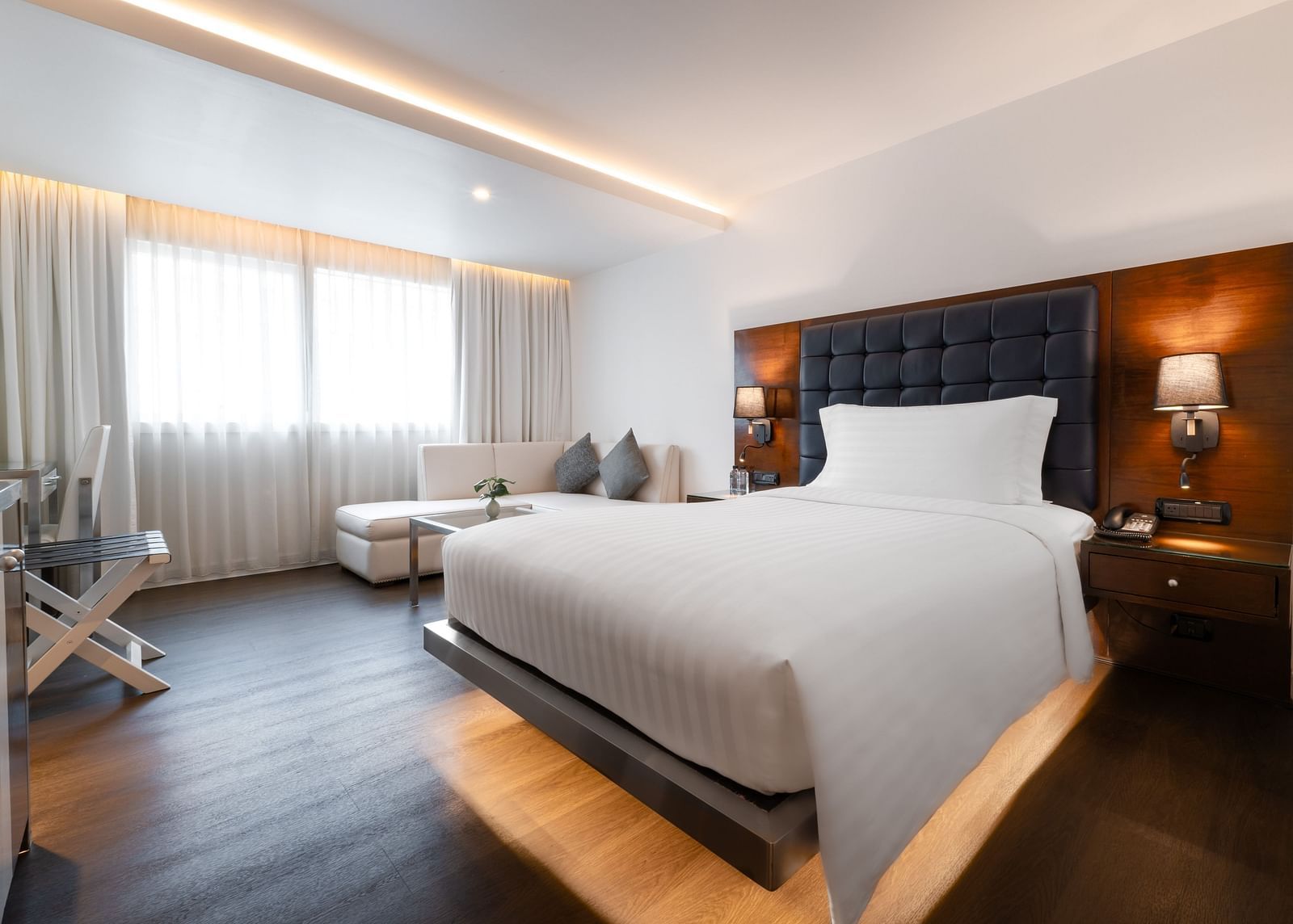 An overview of a double bed with lamps next to the bed inside one of the rooms - Night Hotel Bangkok.
