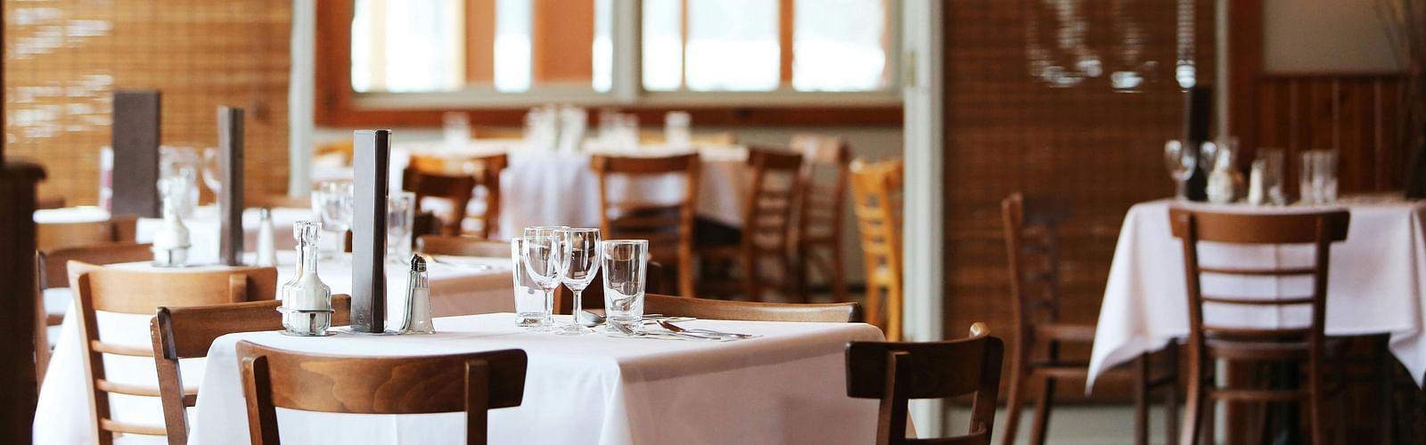 A dining area with comfortable seating, culinary delights neatly arranged on the table, and a warm, inviting ambiance