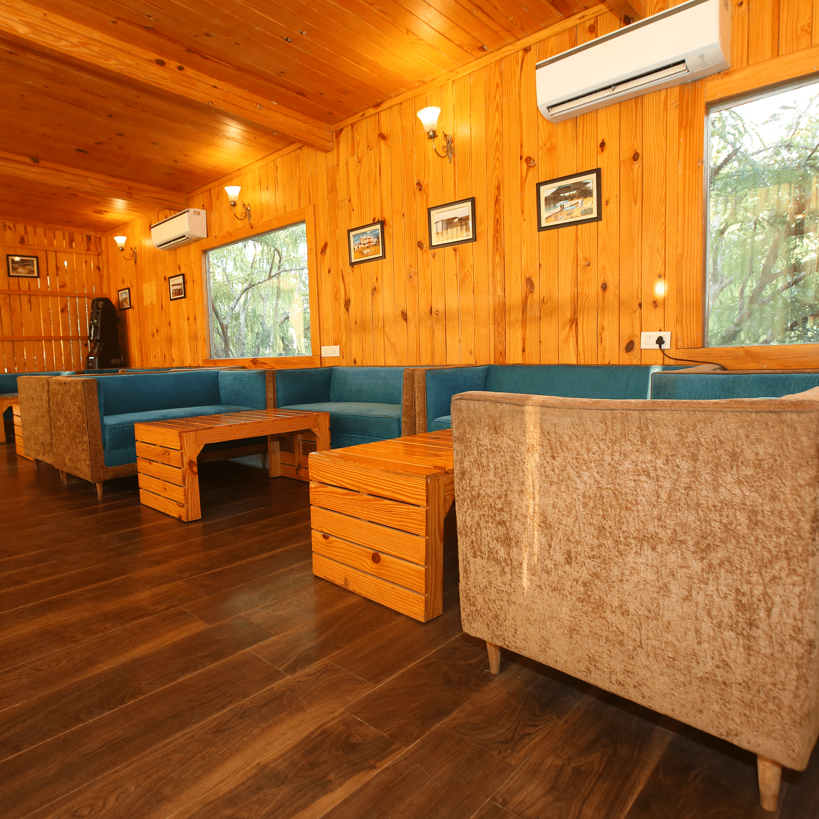 Dining area featuring a large, cozy sofa with a table in front at Aanandam Resort & Spa