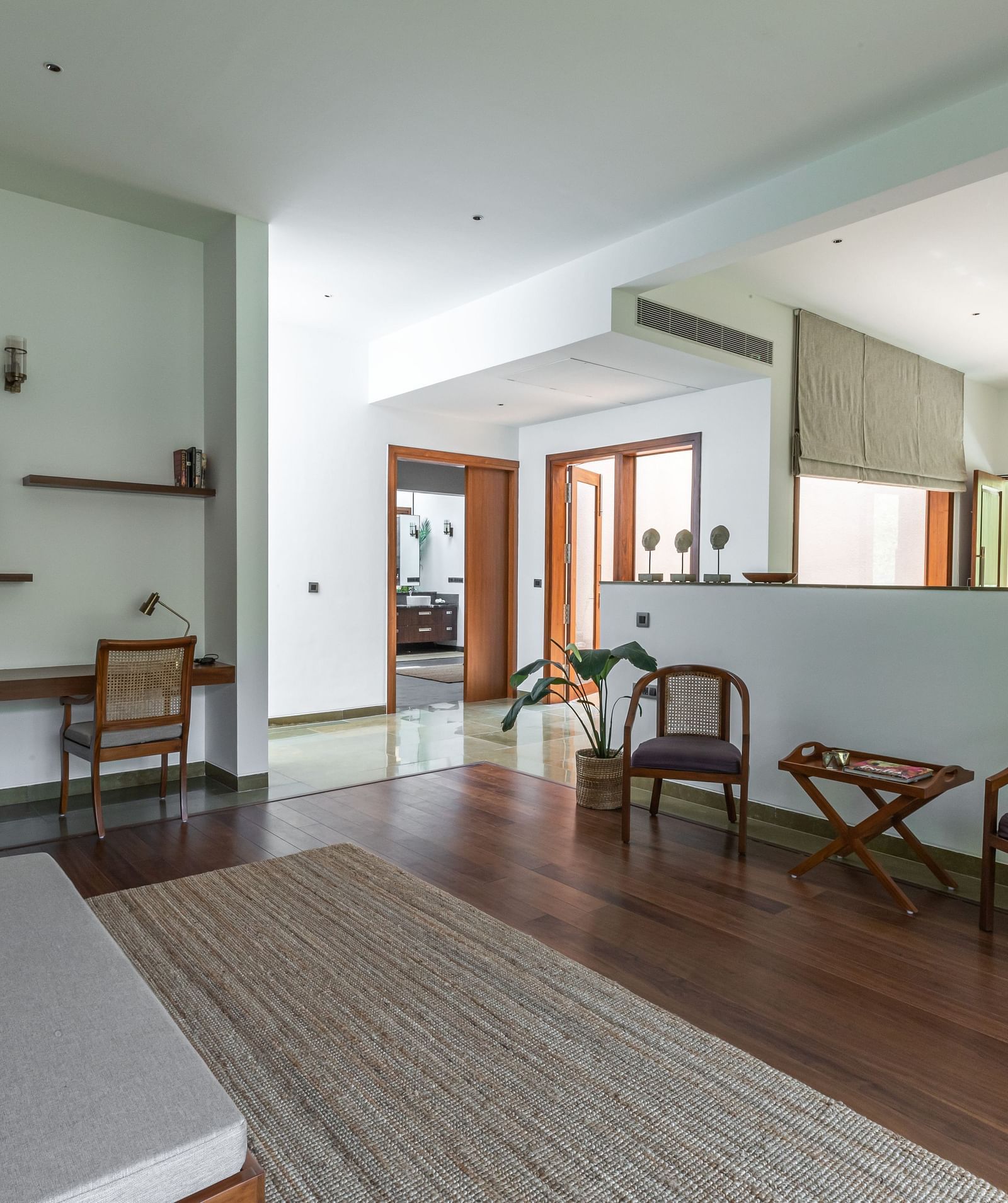 Interior room with a long hallway, chairs, and artwork, bright and spacious design - Shreyas Retreat