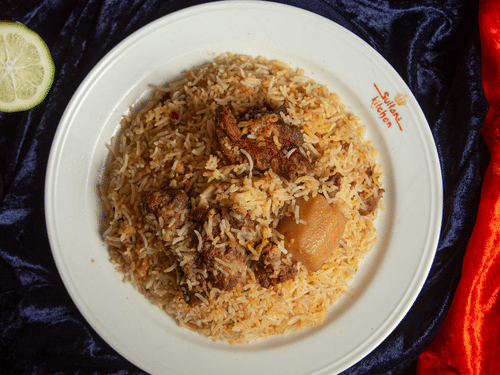 Authentic Kolkata biryani served with fragrant rice, tender meat, and the signature potato.