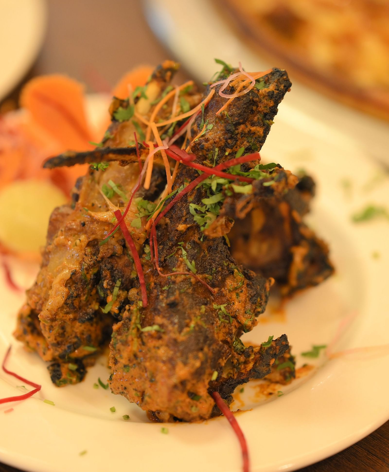 Crispy Indian starter garnished with herbs and spices, served hot at Royal Comfort Regency for an appetising beginning.