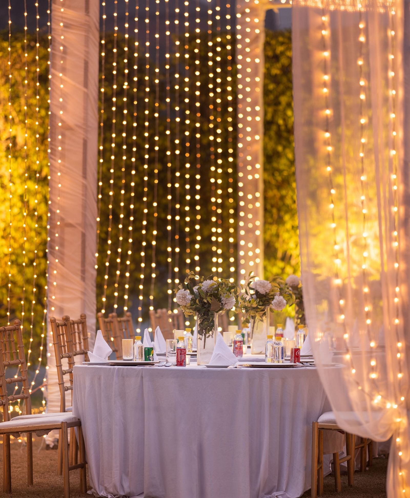 Lavish decoration at an event with a huge table surrounded by chairs at Nirvana Luxury Hotel, Ludhiana.