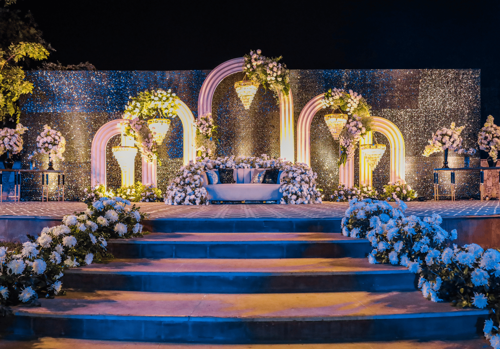 Decorated wedding stage with floral arrangements and arches at Ananta Spa and Resorts, Jaipur.