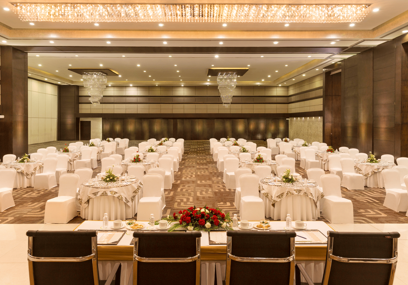 Lavish indoor banquet hall decorated for an event at Narayani Heights Hotel & Resorts, Ahmedabad.