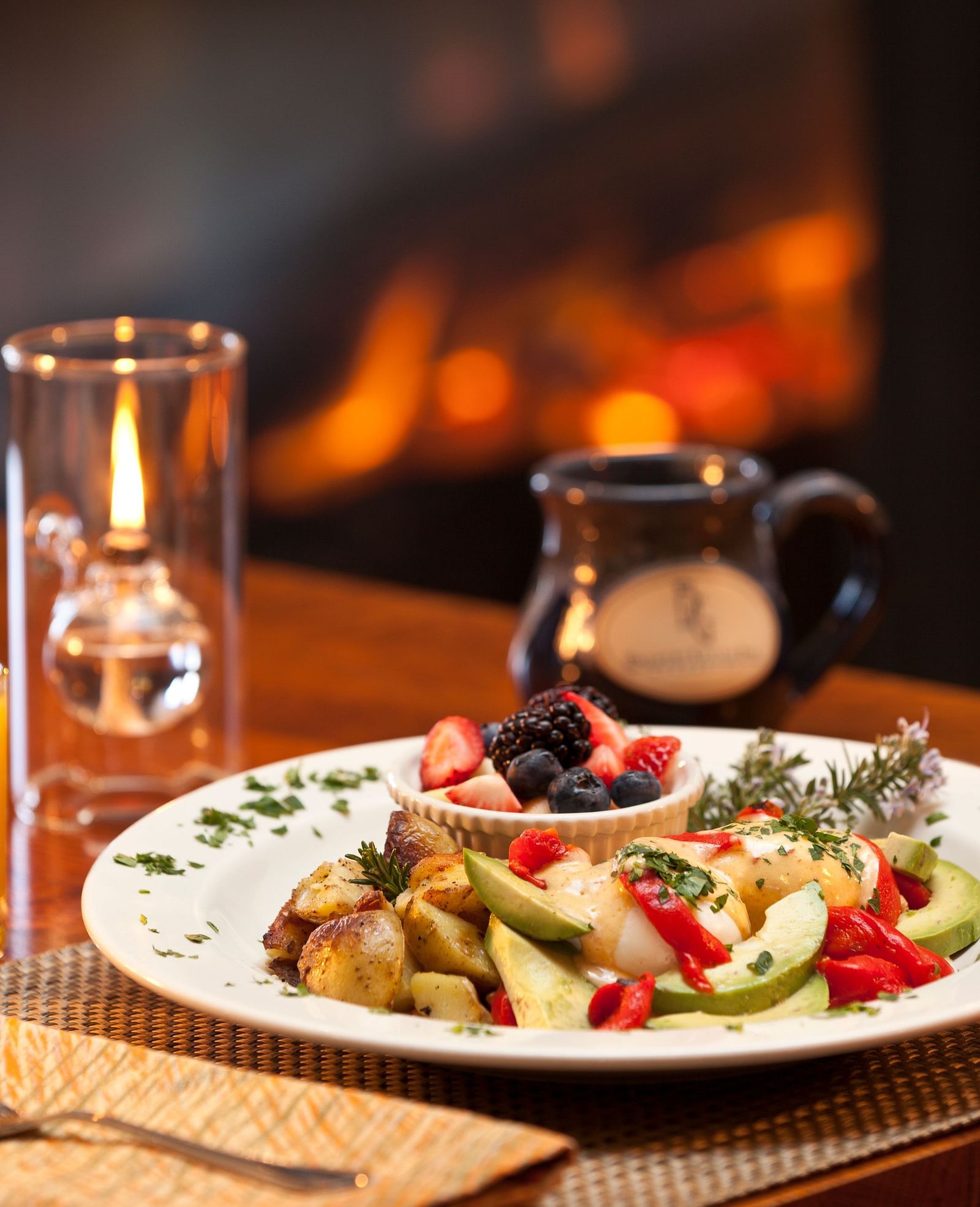 A dish made with potatoes, fruits, and berries, complemented by a side of orange juice - Brewery Gulch Inn & Spa