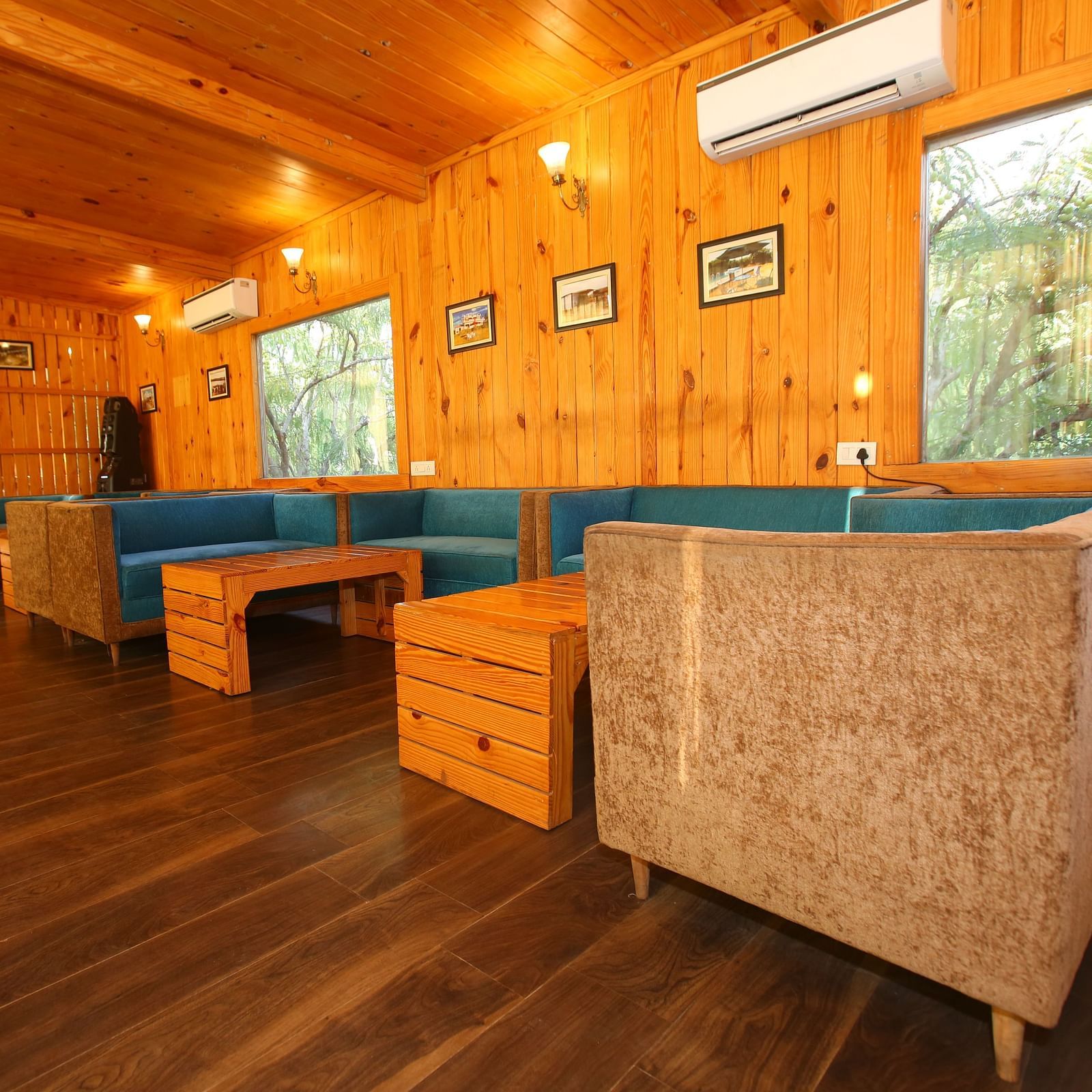 Dining area featuring a large, cozy sofa with a table in front at Aanandam Resort & Spa