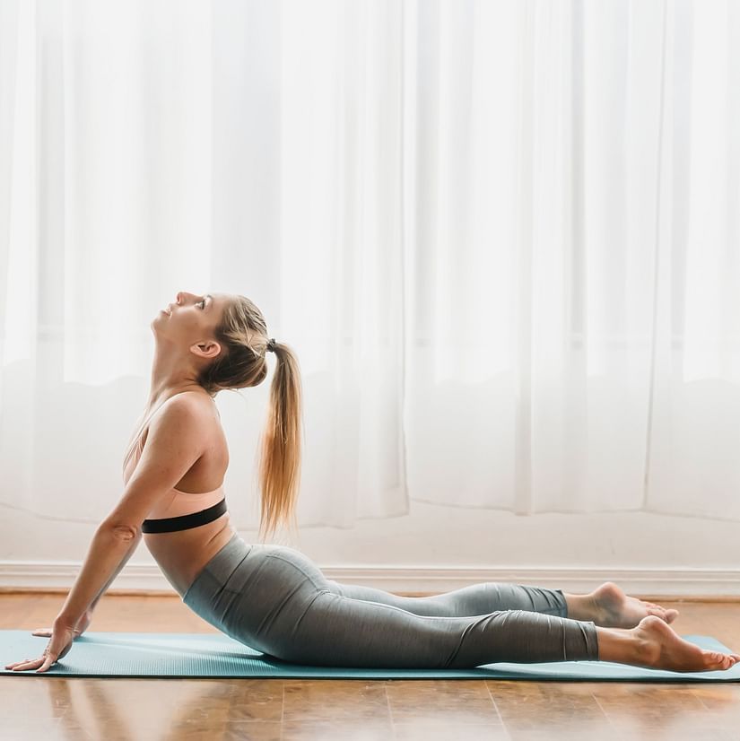 a woman in Bhujangasana yoga pose