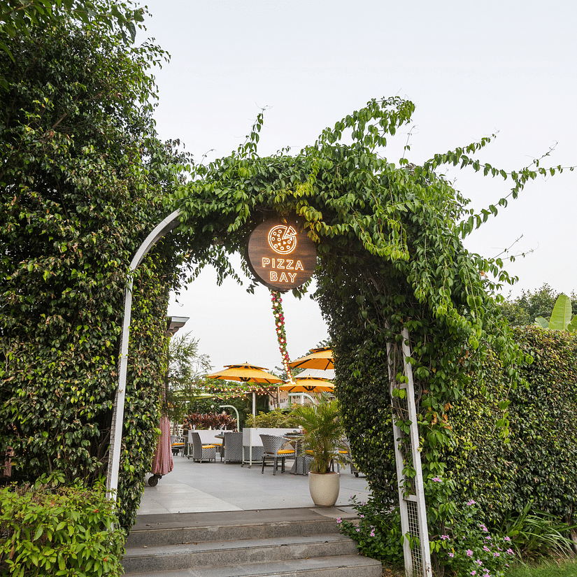 An overview of the entrance to Pizza Bay that is surrounded by greenery - Karma Lakelands.